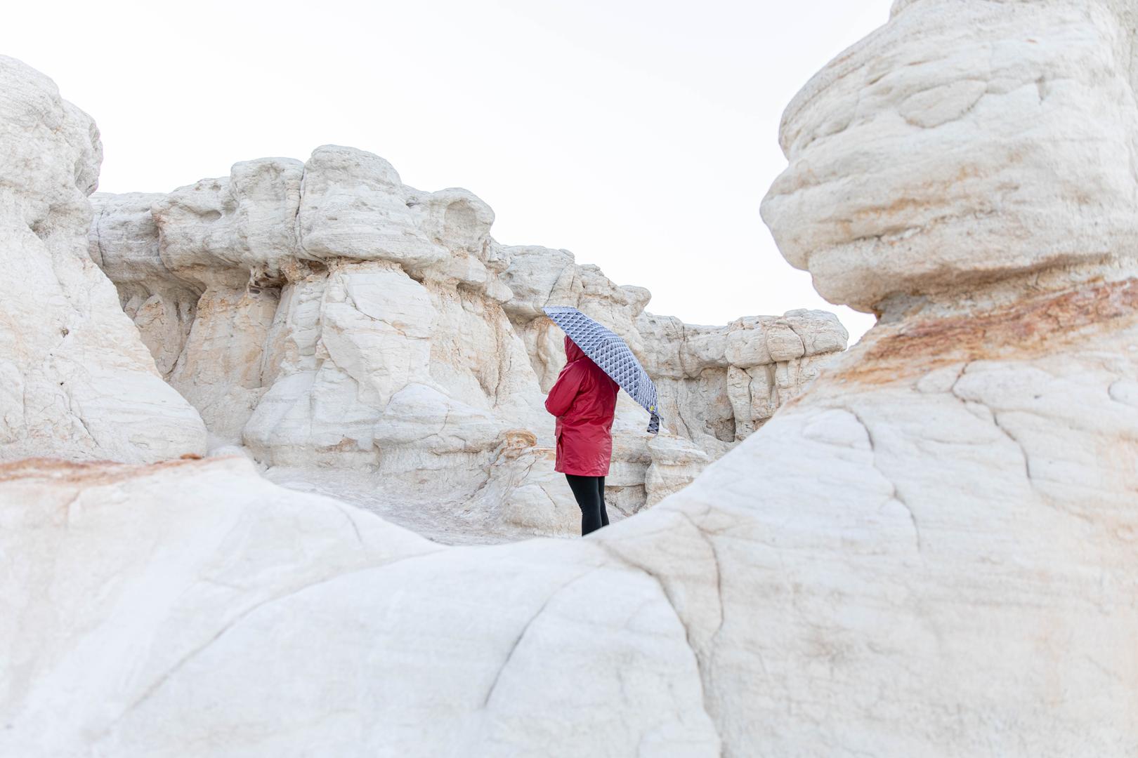 woman standing in between white rocks wearing a re 2025 01 09 12 42 06 utc